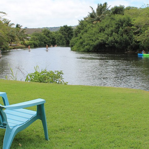 an empty park bench next to a body of water