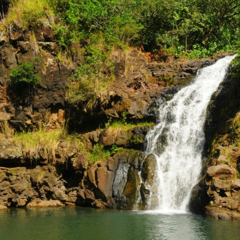 a large waterfall over a body of water