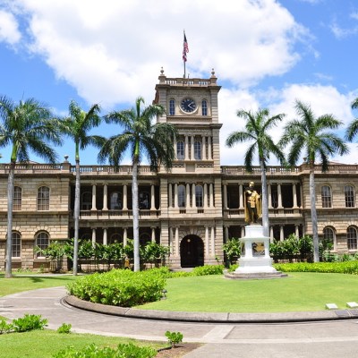 a large stone statue in front of a building