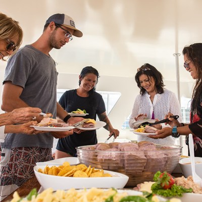 people serving lunch turtle snorkel sail