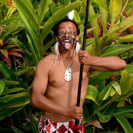 a person standing next to a palm tree