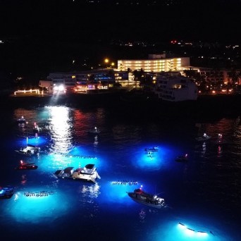 a body of water with a city in the night sky