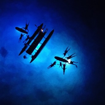 a large airplane flying high up in the dark