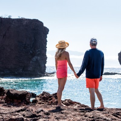 a person standing on a rocky beach