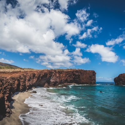 a group of people on a rocky beach