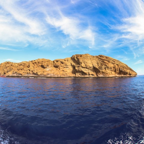 a body of water with a mountain in the background