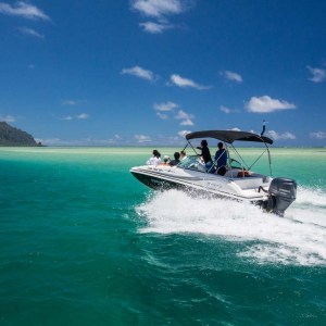 a boat on a body of water next to the ocean