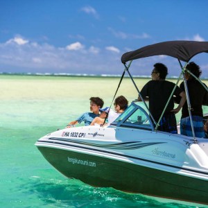 a man riding on the back of a boat in a body of water