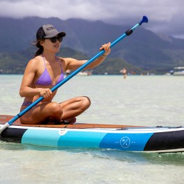 a group of people rowing a boat in a body of water