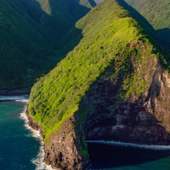 a body of water with a mountain in the background