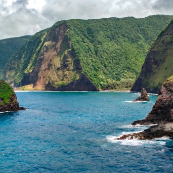 a body of water with a mountain in the background