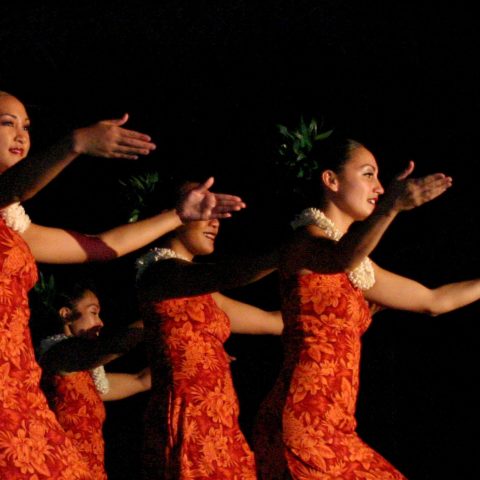 a couple of people that are standing in the dark