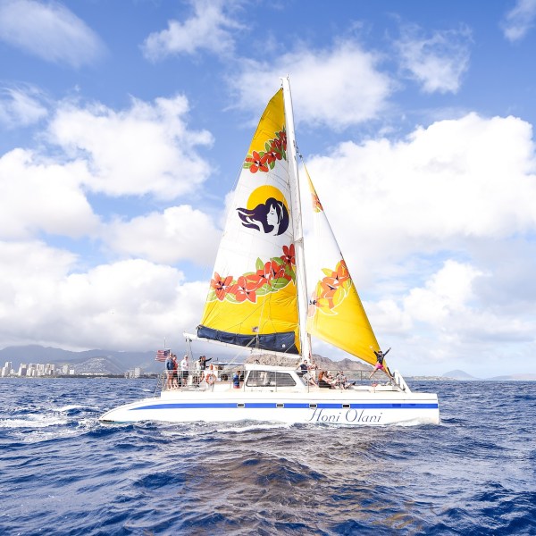 a man flying a kite in a boat on a body of water