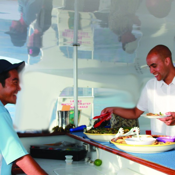 a man and woman preparing food on a table