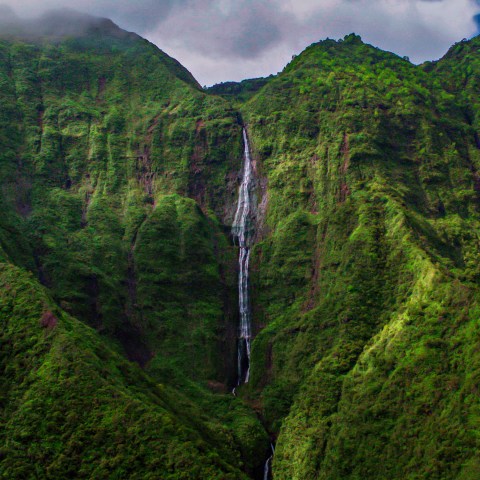 a waterfall with a mountain in the background