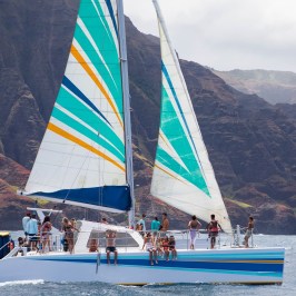 a boat on a body of water with a mountain in the background