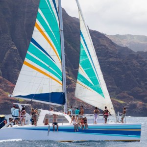 a boat on a body of water with a mountain in the background