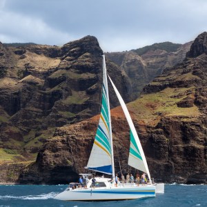 a small boat in a body of water with a mountain in the background