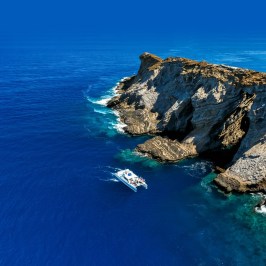 a rocky island in the middle of a body of water