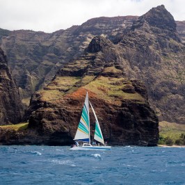 a large body of water with a mountain in the background
