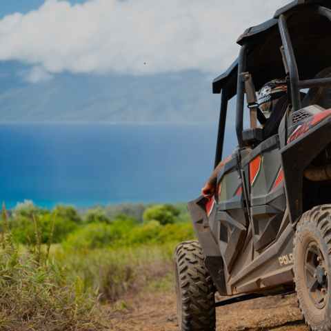 a truck driving down a dirt road