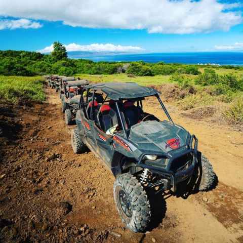 a motorcycle is parked on the side of a dirt road