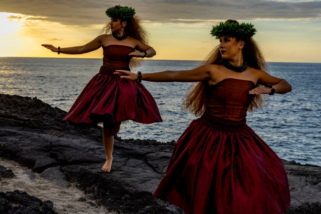 a woman standing in front of a body of water