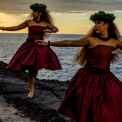 a woman standing in front of a body of water