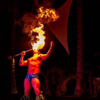 a man standing in front of a fire