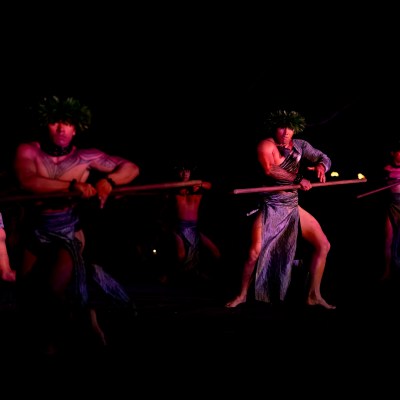 a couple of people that are standing in the dark