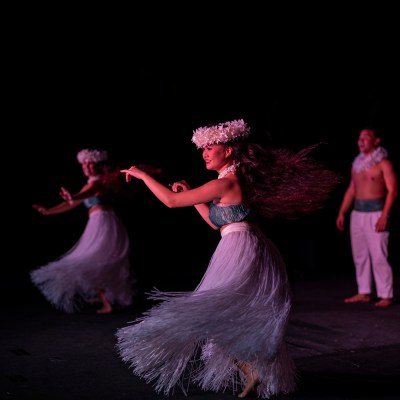 a person jumping up in the dark