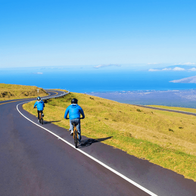 a man riding a bike down a dirt road