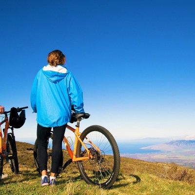 a man standing next to a bicycle