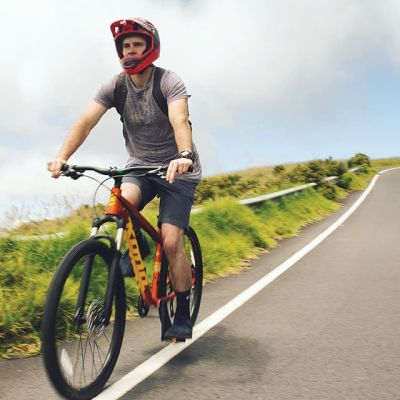 a person riding a bicycle on the side of a road