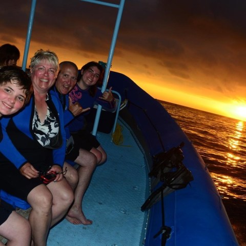 a group of people sitting at a beach