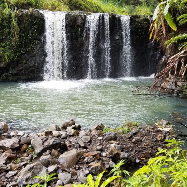 a large waterfall over a rocky cliff