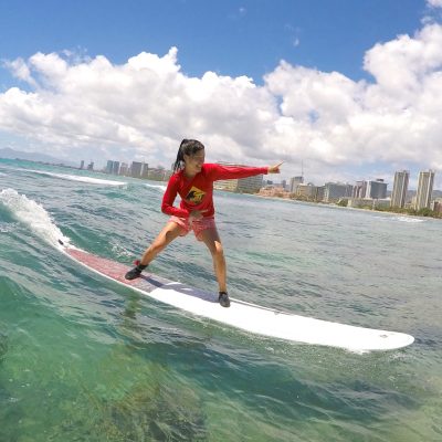 a man riding a wave on a surf board on a body of water