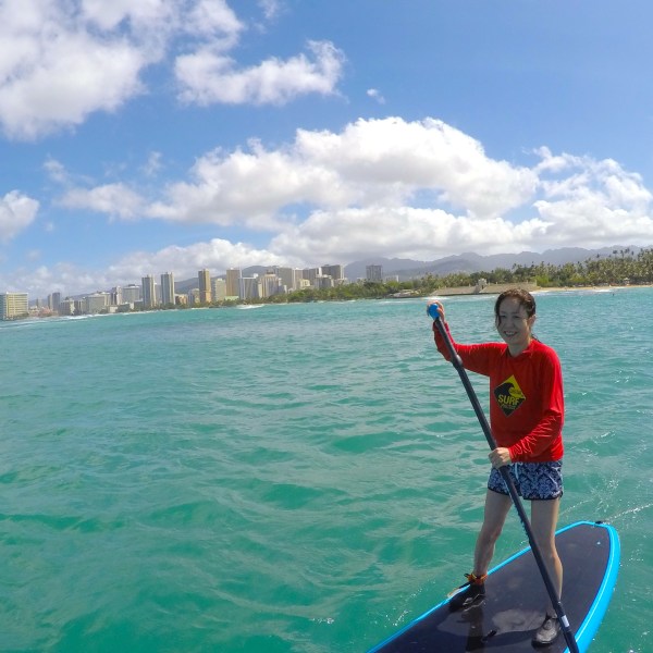 a man standing next to a body of water