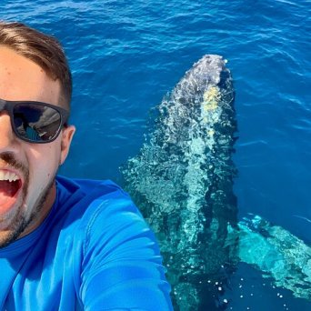 a man holding a fish swimming under water