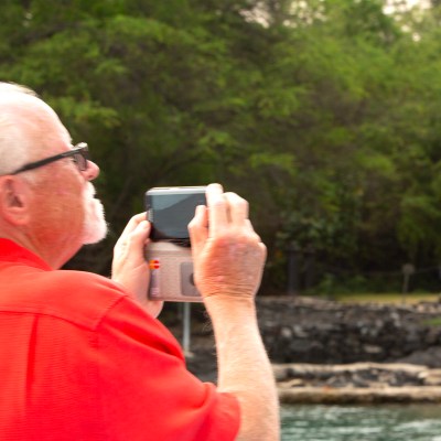 Tourist taking a photo of historic landmarks from the cruise