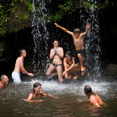 a group of people swimming in a pool of water