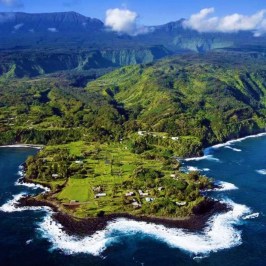 a body of water with a mountain in the background