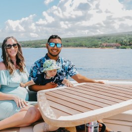a woman sitting on a dock next to a body of water