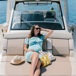 a woman sitting on a boat in the water