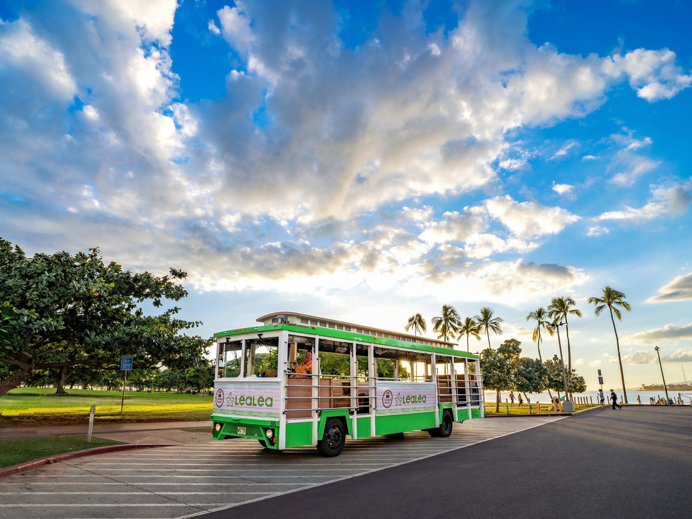 a passenger bus that is parked on the side of a road