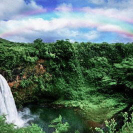 a rainbow over a waterfall