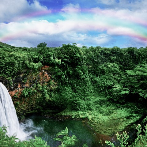 a rainbow over a waterfall