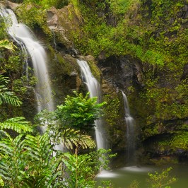 a large waterfall over a body of water