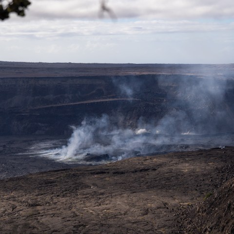 a train on a track with smoke coming out of it