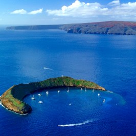 a body of water with Molokini in the background